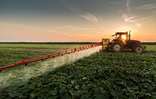 Tractor spraying field