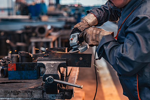 worker grinding metal
