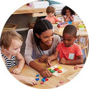 teacher smiles while students work